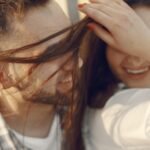 A close-up of a joyful couple sharing an intimate and playful moment, laughing together.